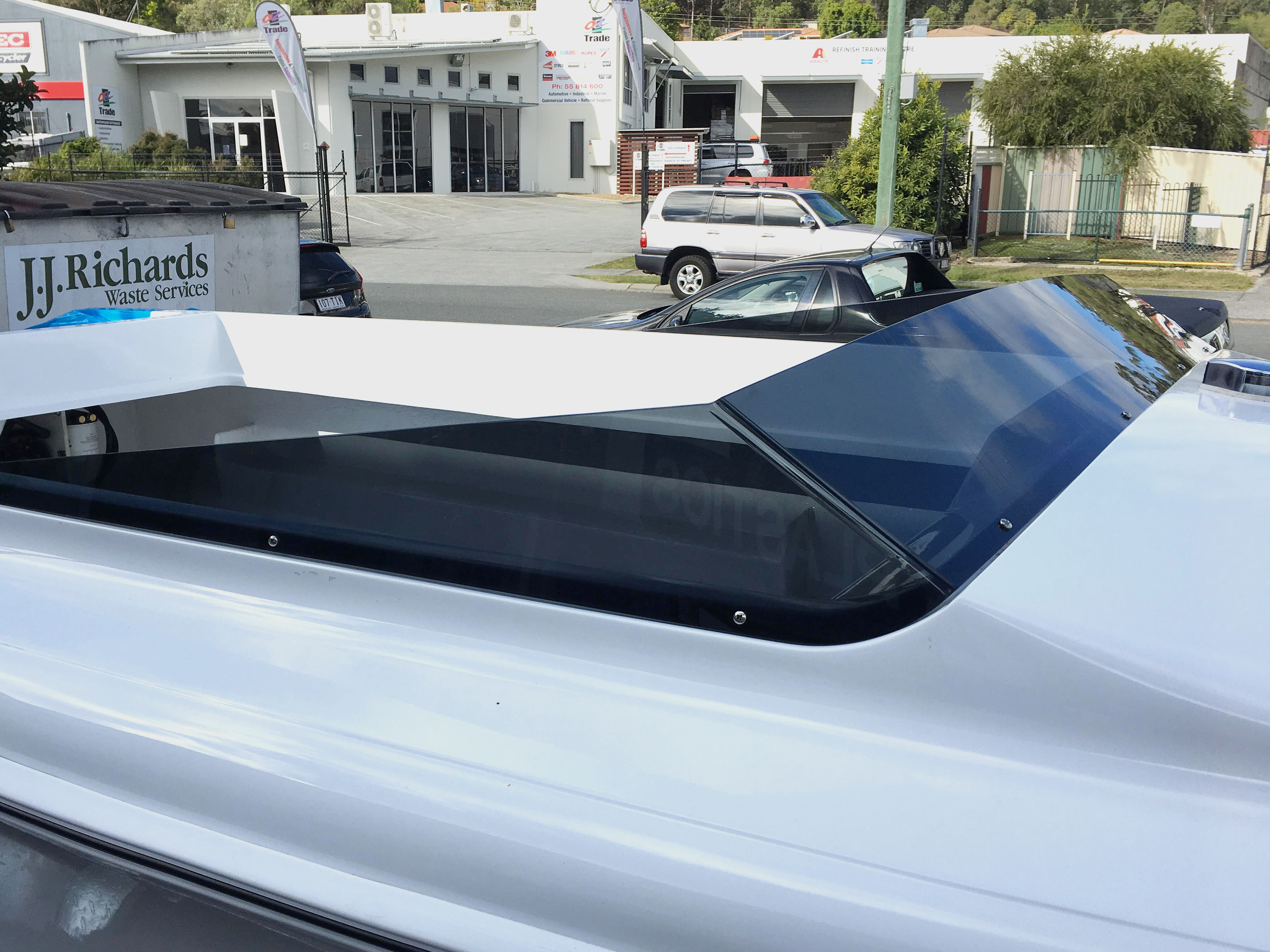 Custom dark-tint acrylic boat windscreen fabricated by P&M Plastics in our Gold Coast workshop