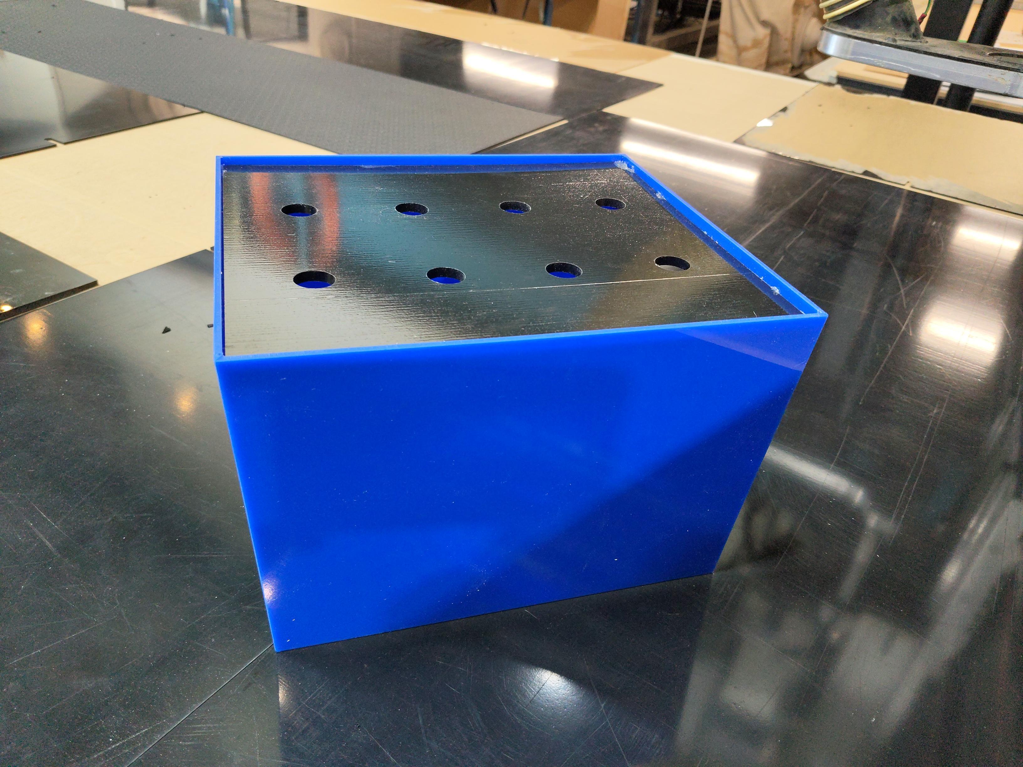 Blue acrylic battery box top-down view with lid closed